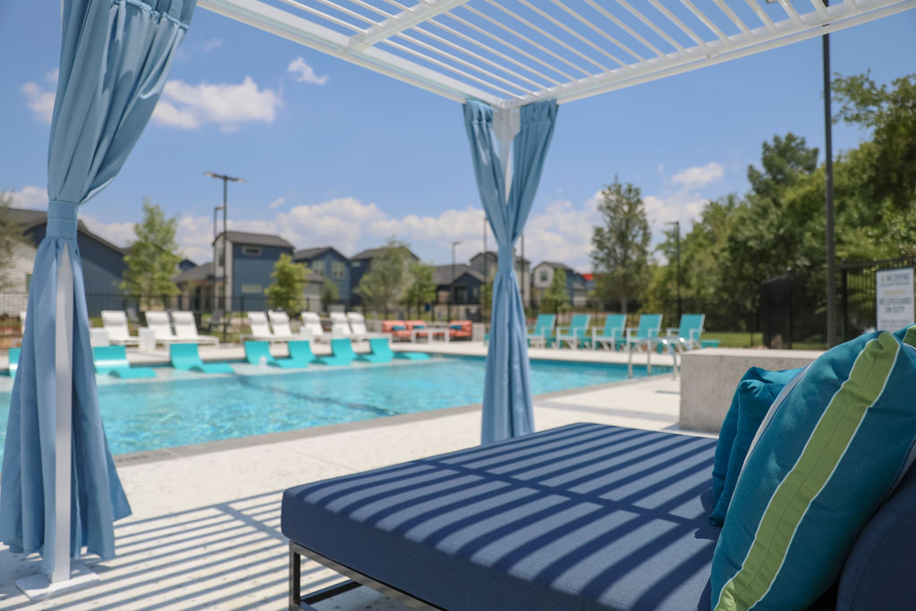 Community pool with lounge seating at The parcHAUS at Firewheel Parkway